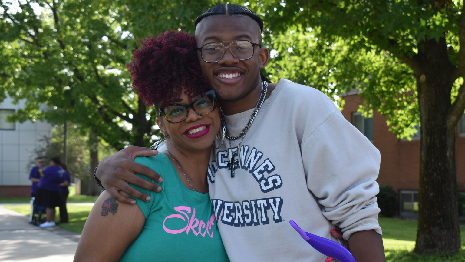 Mom and son posing for the camera on move in day