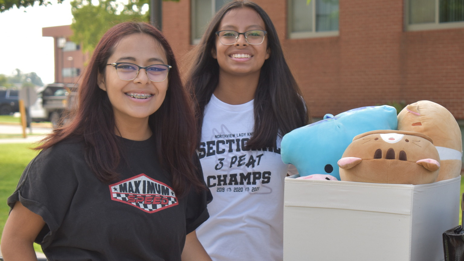 Sisters posing for the camera during move in day