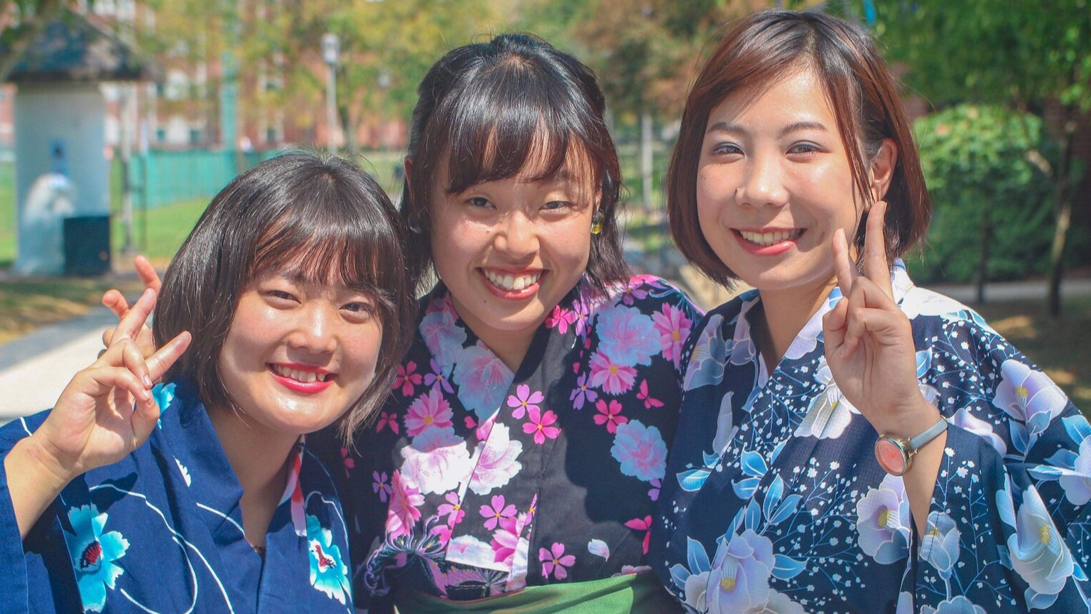 Three family members posing for the camera in traditional clothing