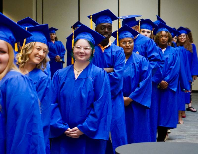 The ABE Graduates wait excitedly in line waiting to walk in their graduation