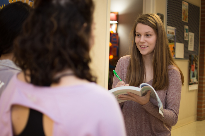 A behavioral studies student interviewing two other students