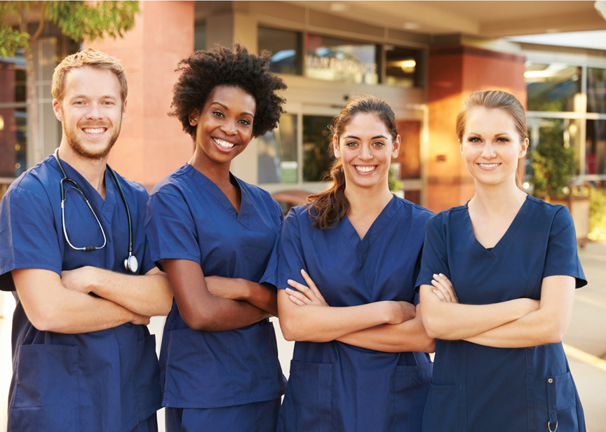 A team of nurses posing in front of their clinic