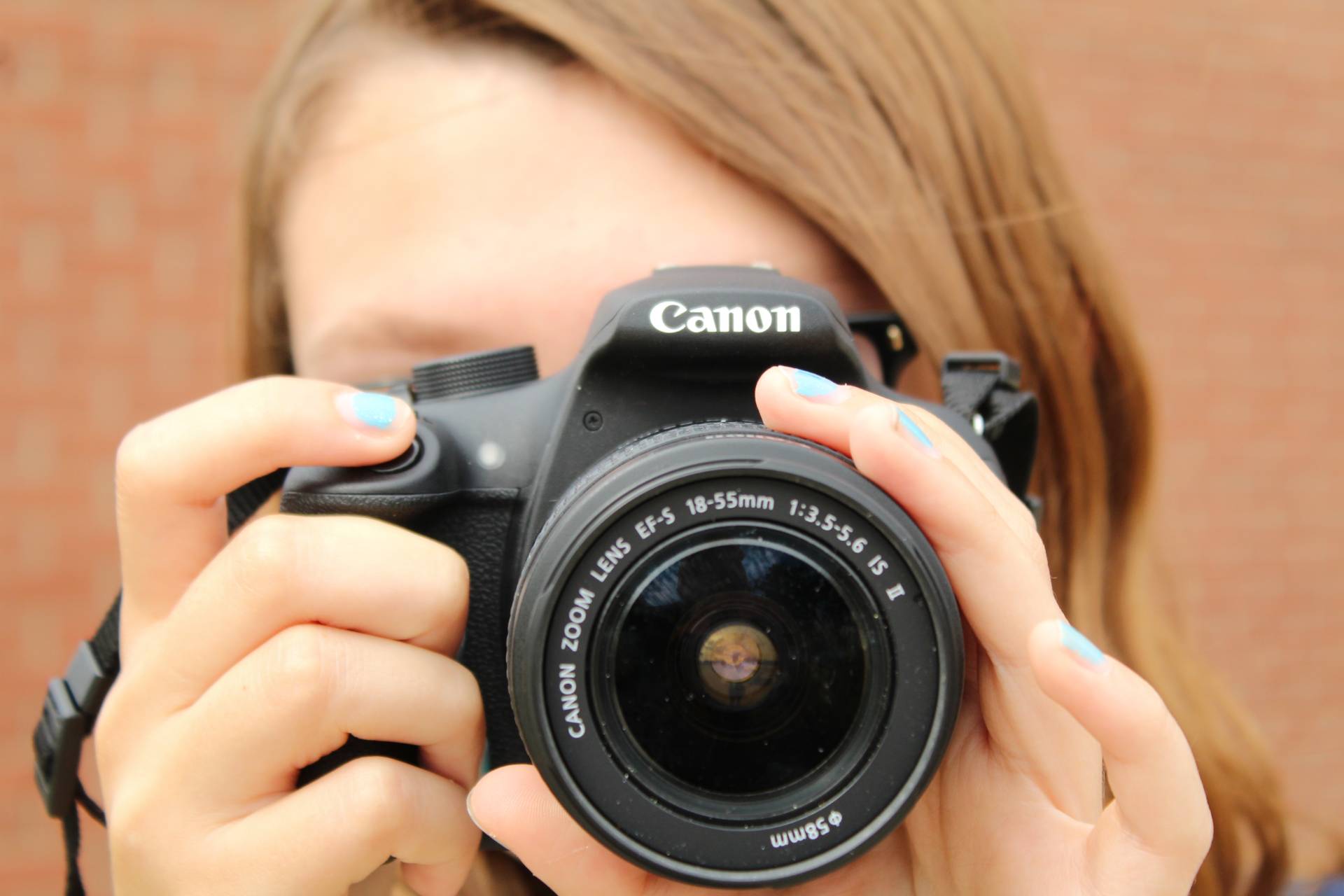 A female student holding a camera