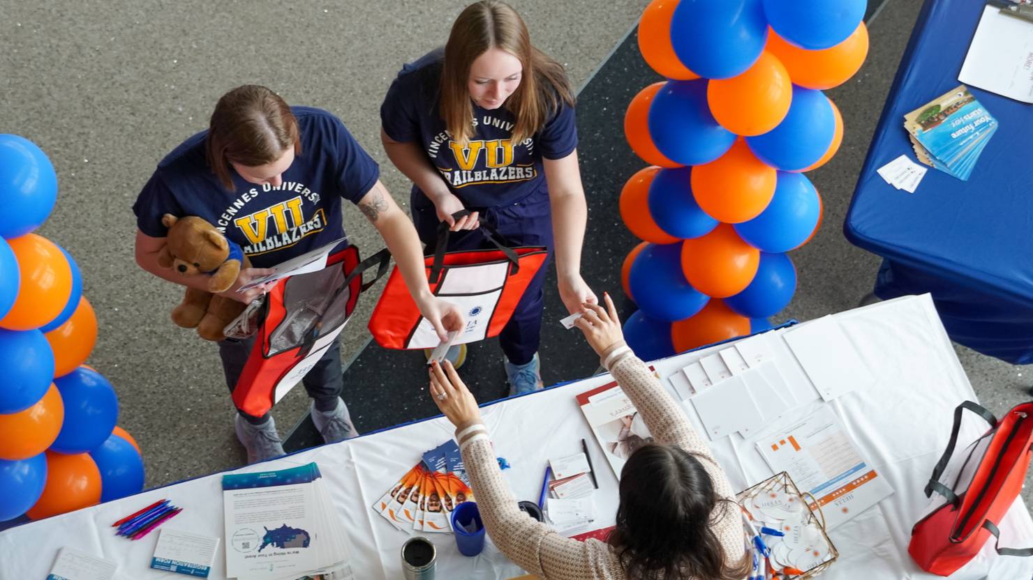Students at the  career fair get information from a booth
