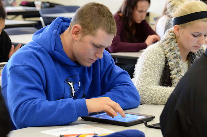 A student working on a tablet in a classroom