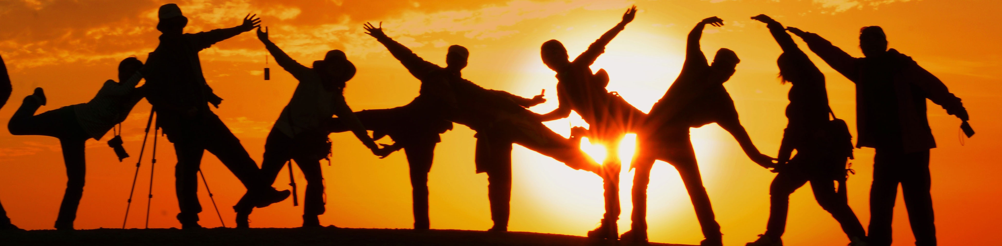 A photo of a group of children playing at sunset