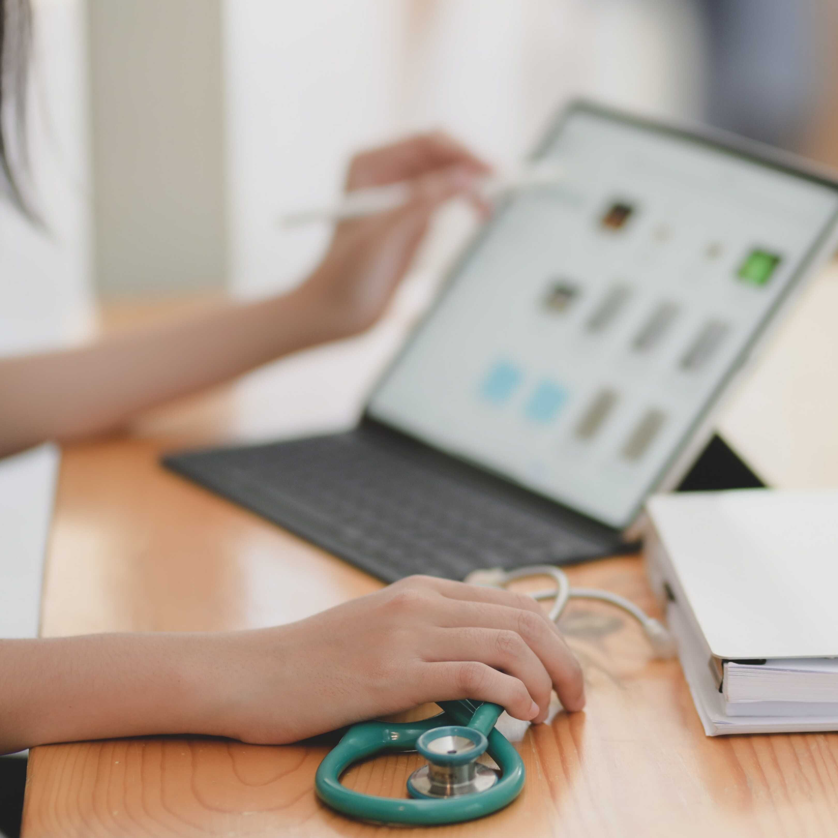 A health care worker using a laptop