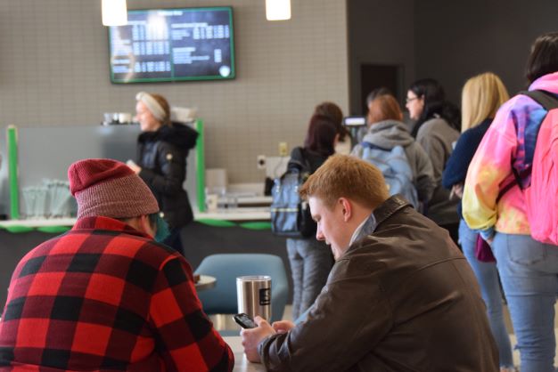 Students waiting outside Starbucks at Shake Resource Center