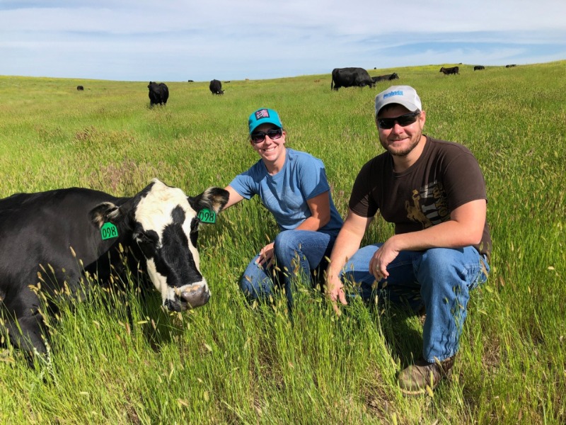 Student and instructor are in a field with livestock