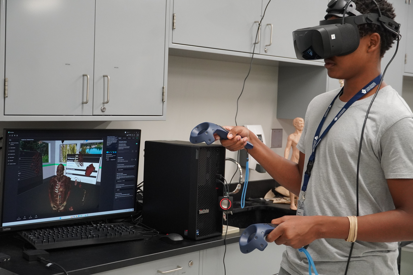 A Vincennes University student uses a VR headset to navigate a program