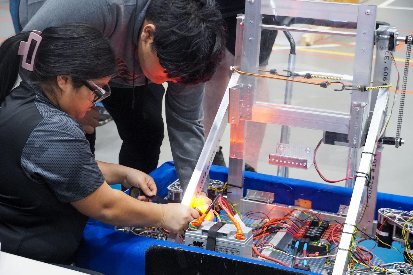 Vincennes University students work together to program a circuit board.