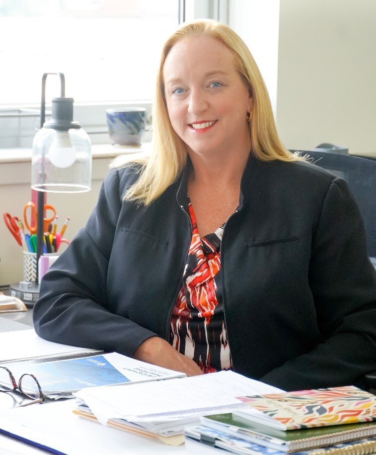 Kim Wright sitting at her desk.