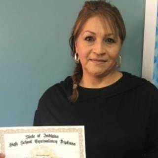 ABE student Lucy Dominguez posing with her certificate