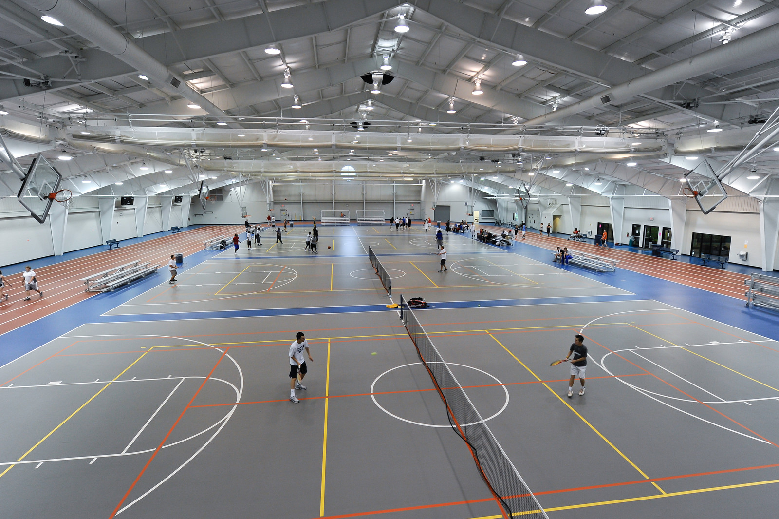 Students playing tennis in the Rec Center