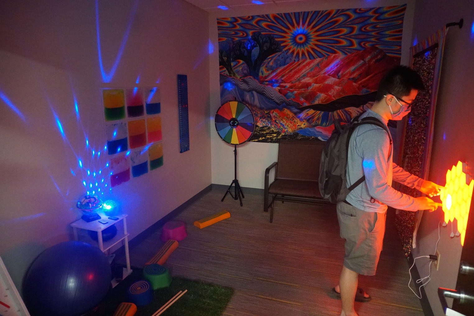 A student in a room with many flashing lights