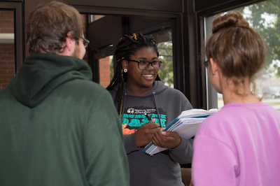 A social work major interviewing two other students