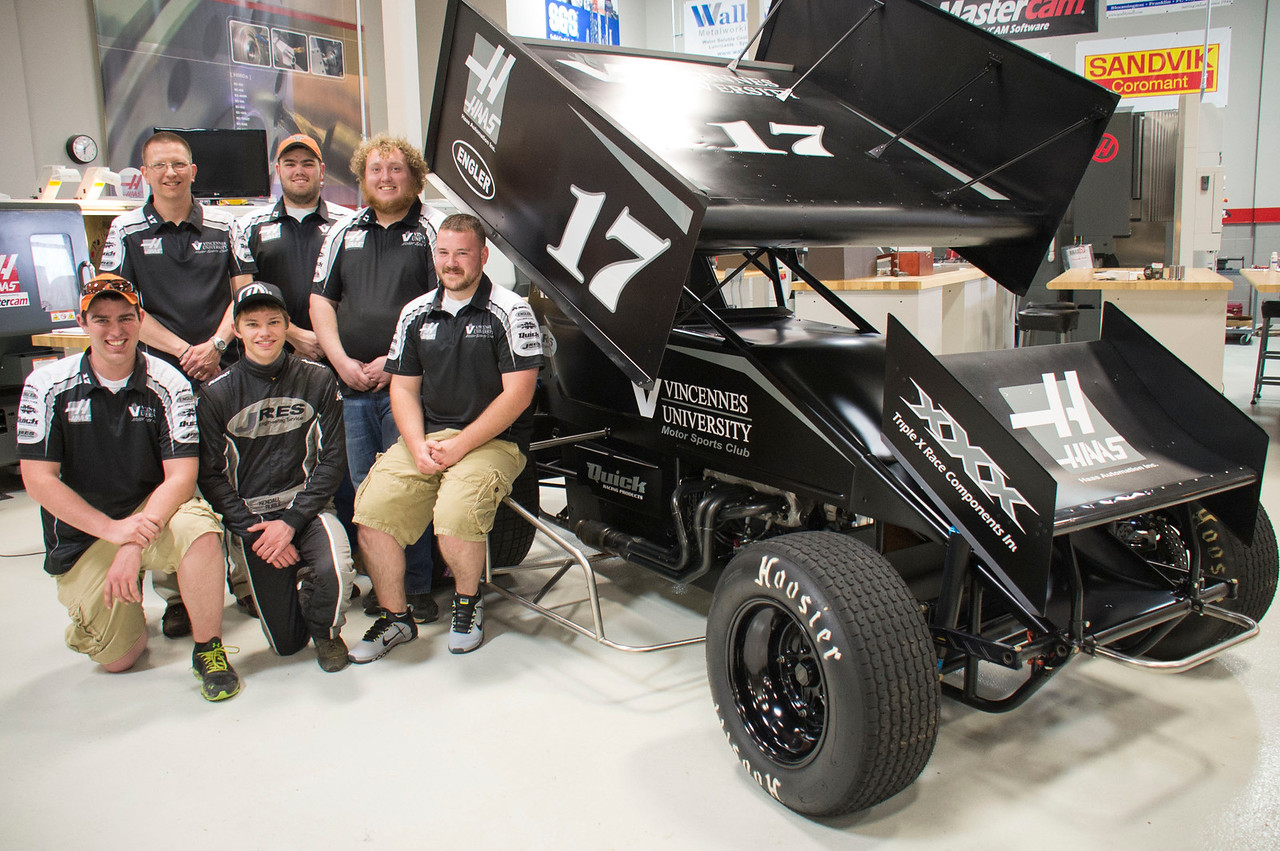 The Vincennes University Motor Sports Club posing for a photo next to a custom vehicle