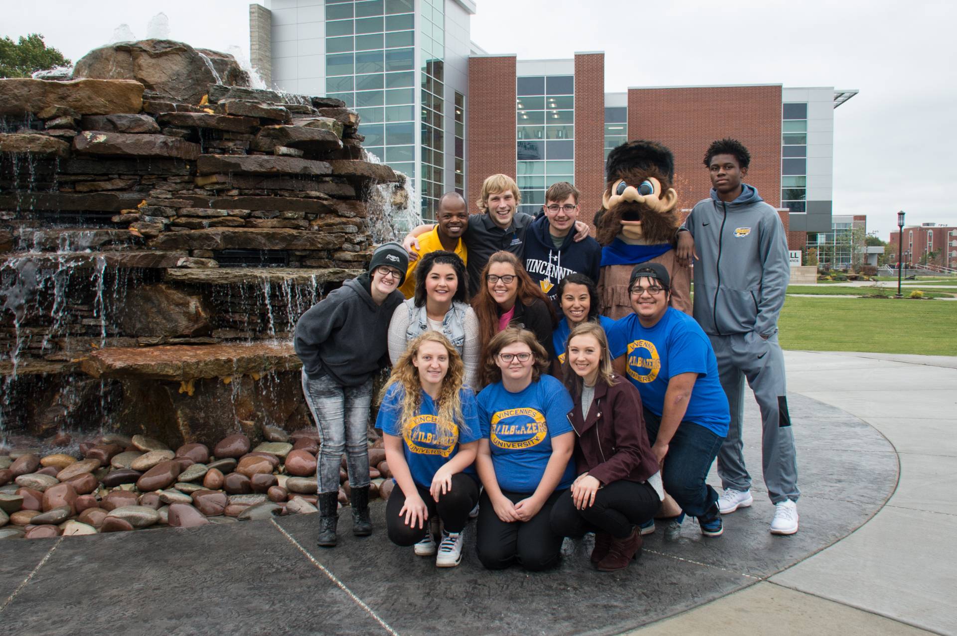 A group of student posing for a photo at Updike Fountain