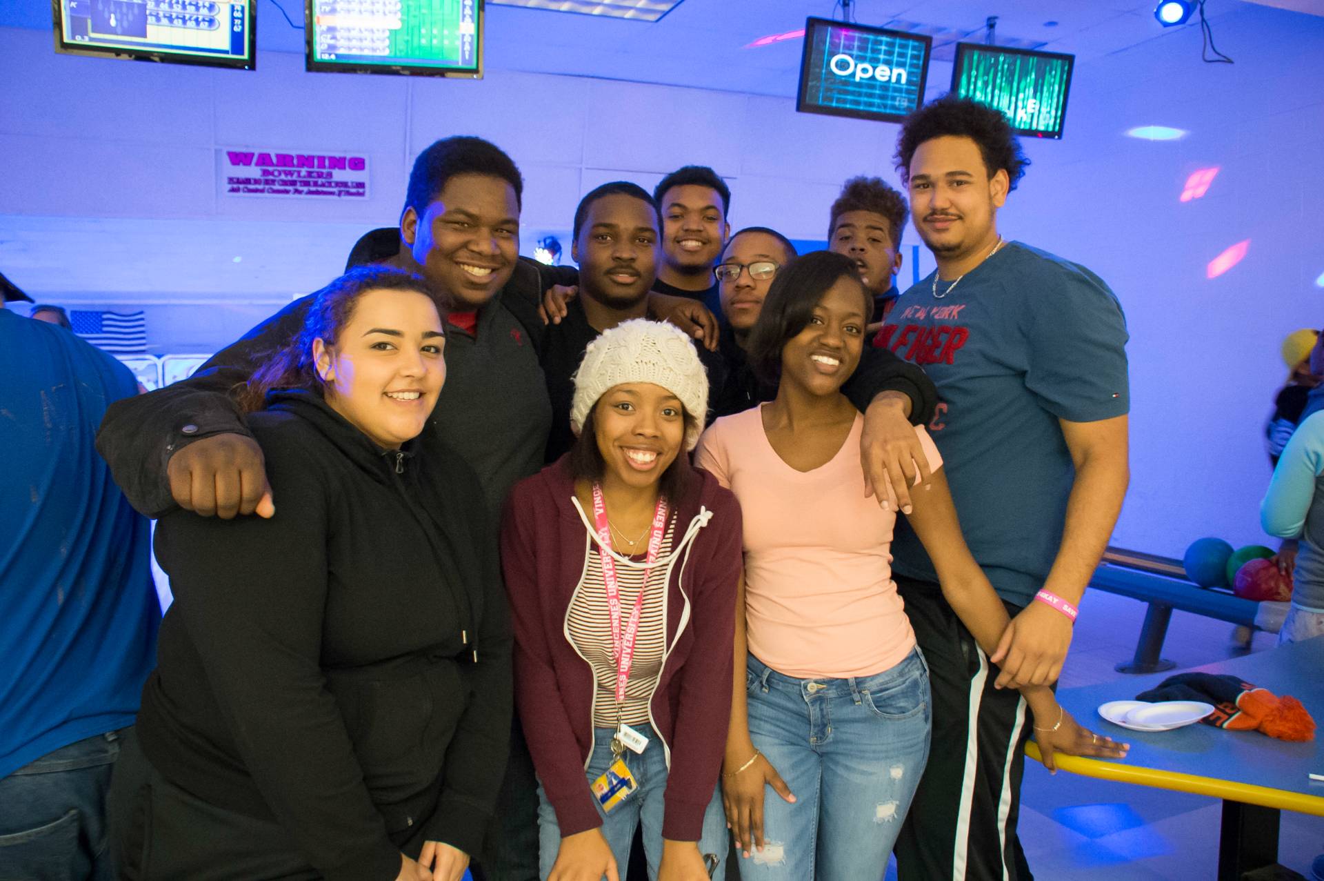 A group of students posing for a photo at the bowling alley