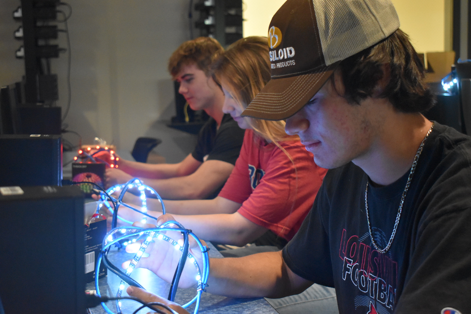 Three students staring at glowing balls