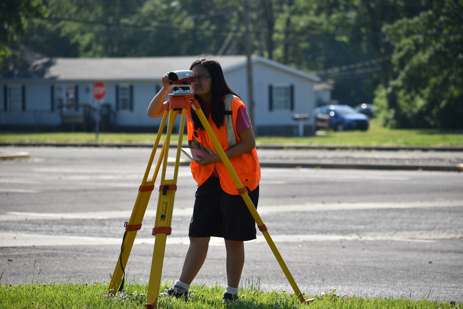 A female student looking into a surveying camera