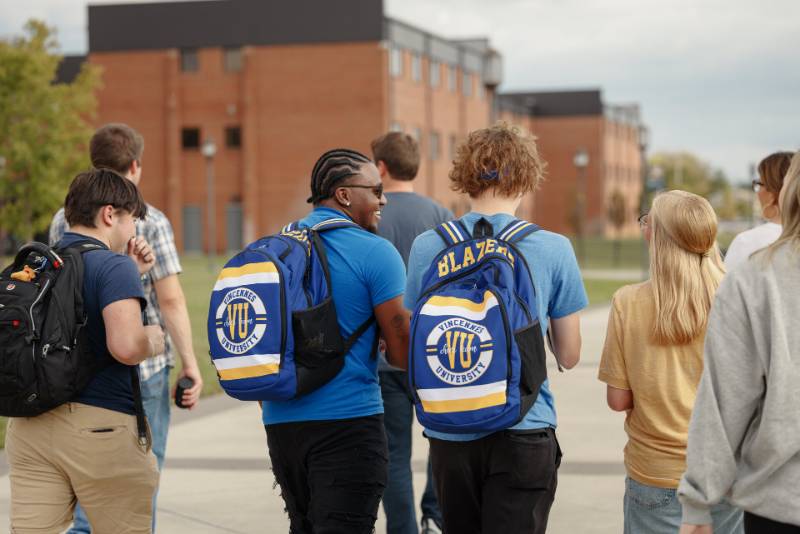 Vincennes University Students Walking in a Group Laughing and Talking Online