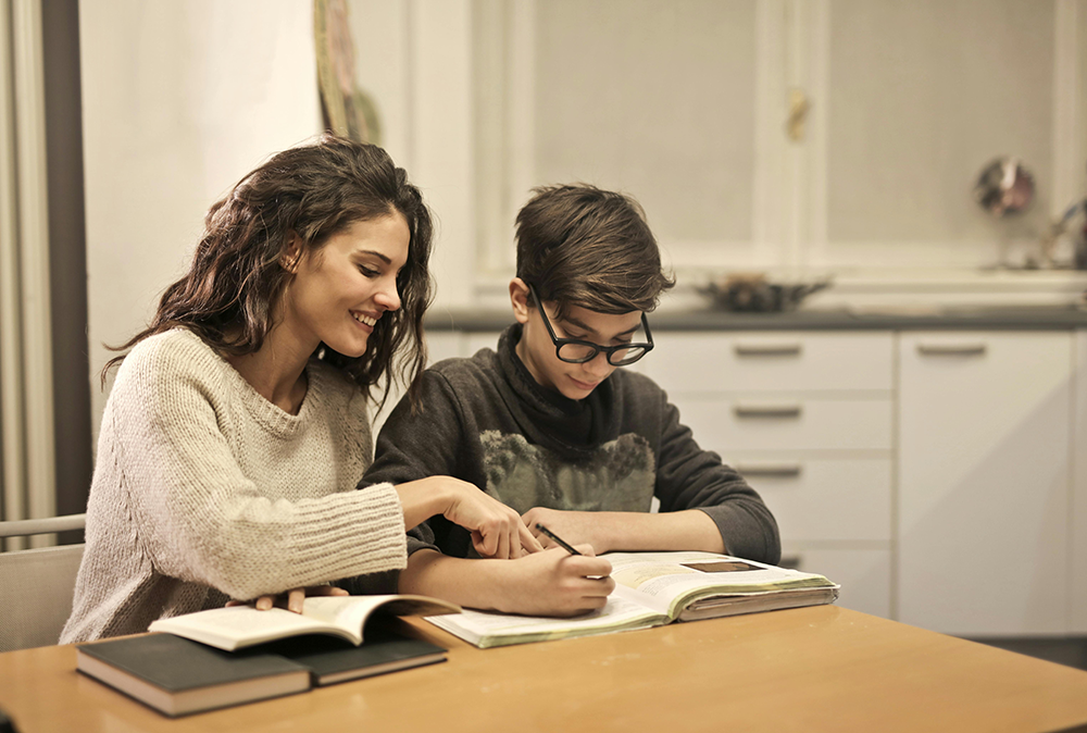 Mother working through a lesson with her son.